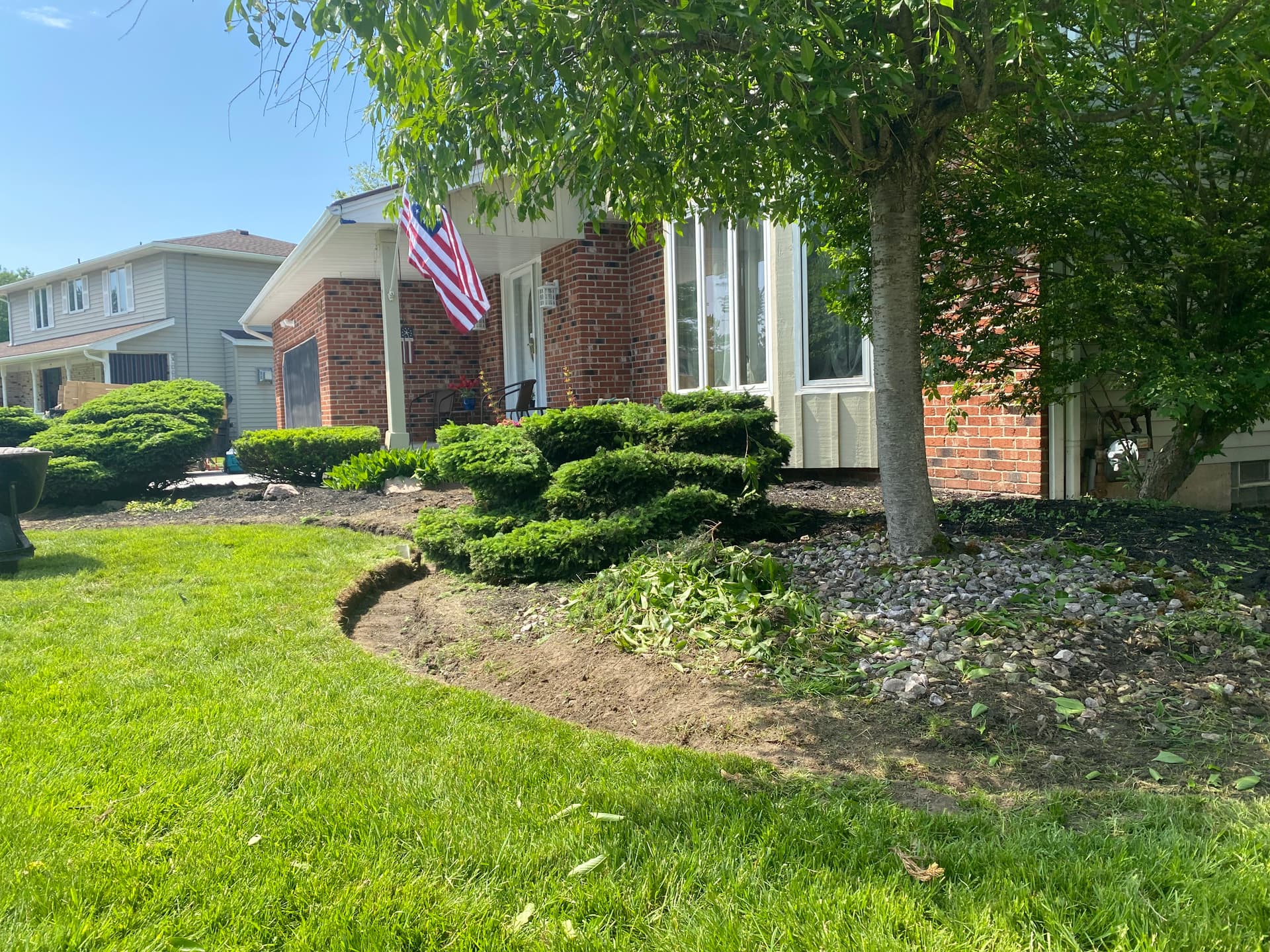 Elegant Lawn Upgrade with Stone Beds and Mulch Edging