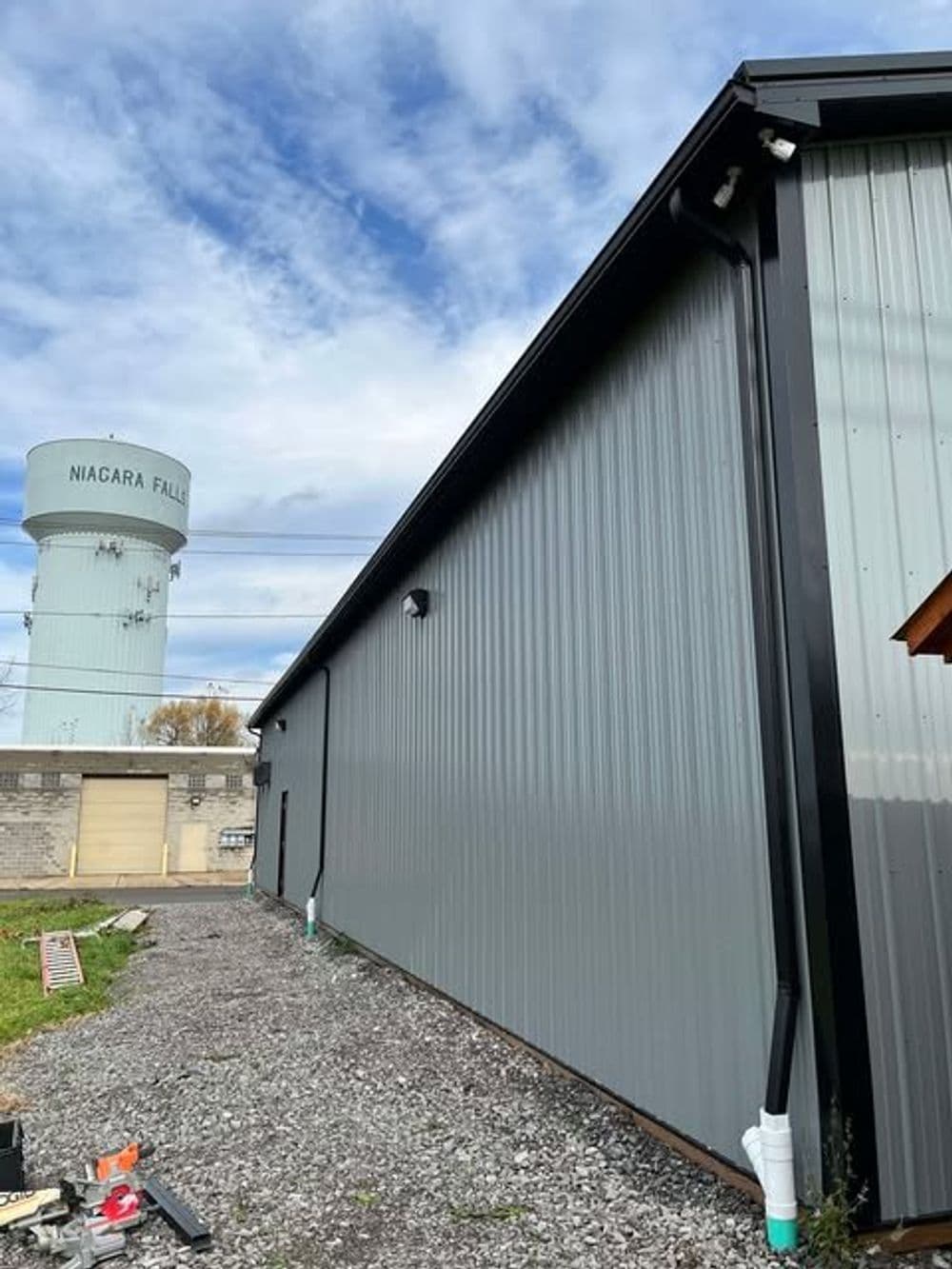 Side view of a modern building in Niagara Falls, with a water tower in the background.